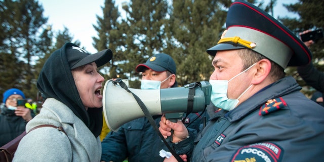 FILE - A woman argues with police officer during a protest in support of jailed opposition leader Alexei Navalny in Ulan-Ude, the regional capital of Buryatia, a region near the Russia-Mongolia border, Russia, in this Wednesday, April 21, 2021, file photo. (AP Photo/Anna Ogorodnik, File)