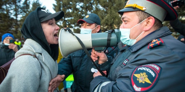 FILE - A woman argues with police officer during a protest in support of jailed opposition leader Alexei Navalny in Ulan-Ude, the regional capital of Buryatia, a region near the Russia-Mongolia border, Russia, in this Wednesday, April 21, 2021, file photo. (AP Photo/Anna Ogorodnik, File)