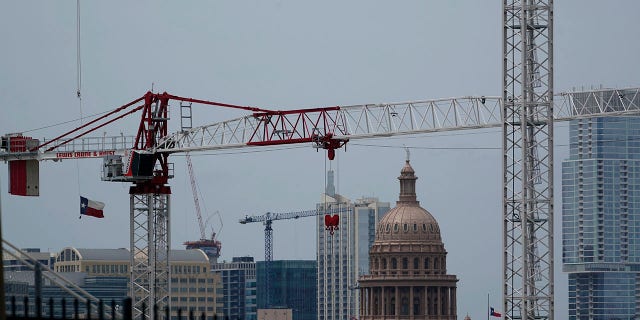 Construction cranes hover over downtown and near the State Capitol, Monday, April 26, 2021, in Austin, Texas. Texas' torrid growth over the past decade is paying off with a major boost in political clout. (AP Photo/Eric Gay)