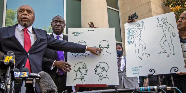 Attorneys for the family of Andrew Brown Jr., Wayne Kendall, left, and Ben Crump, center, hold a news conference Tuesday, April 27, 2021 outside the Pasquotank County Public safety building in Elizabeth City, N.C., to announce results of the autopsy they commissioned. (Travis Long/The News & Observer via AP)
