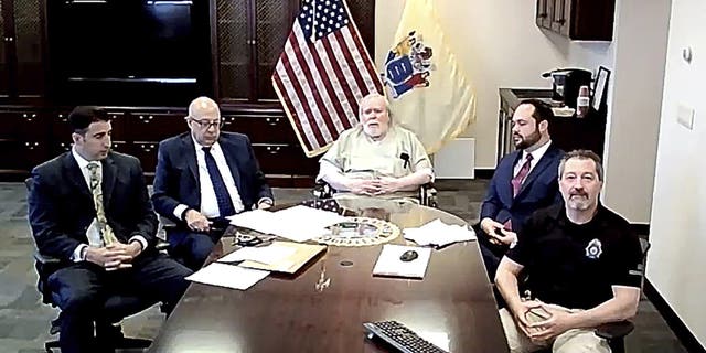 In this image taken from a New Jersey Courts virtual hearing, Richard Cottingham, center, known as the "Torso Killer," pleads guilty Tuesday, April 27, 2021, to two 1974 murders, finally closing the cold case deaths of teenage friends who had left home for a trip to the mall and never returned.