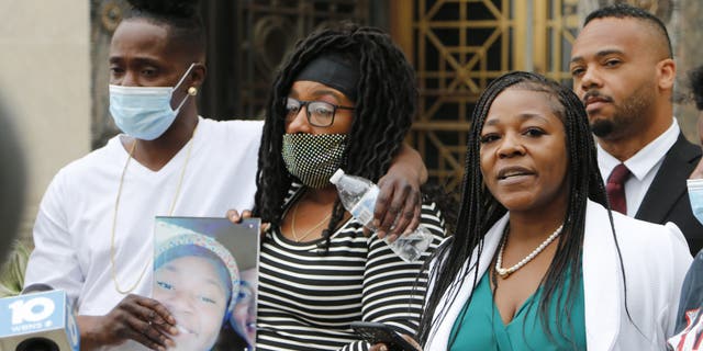 Myron Hammonds, left, and Paula Bryant, center, father and mother of Ma'Khia Bryant, the 16-year-old girl shot and killed by a Columbus police officer on April 20, stand next to family attorney Michelle Martin during a news conference Wednesday in Columbus, Ohio. (AP Photo/Jay LaPrete)