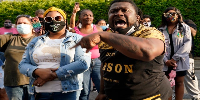 People gather outside the municipal building Wednesday following the shooting of Brown in Elizabeth City, North Carolina. (AP)