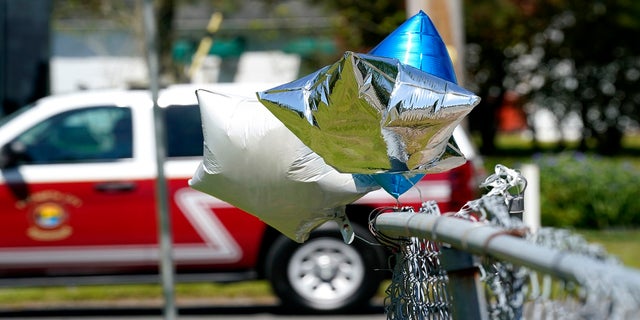 Balloons are seen tied to a fence in Elizabeth City, N.C., at the scene where Brown was shot. (AP)