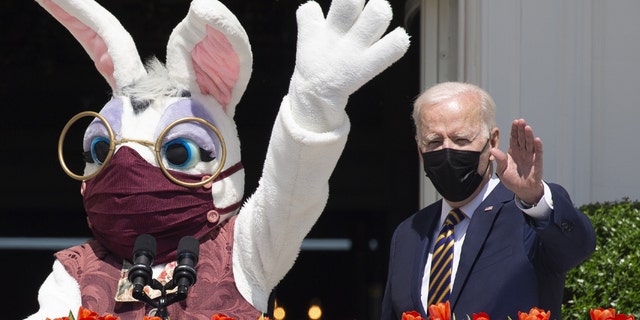 President Biden, right, beside a costumed Easter bunny from the Truman Balcony of the White House in Washington, D.C., on Monday, April 5, 2021. Biden and the bunny, both outdoors, are wearing masks. (Michael Reynolds/EPA/Bloomberg via Getty Images)