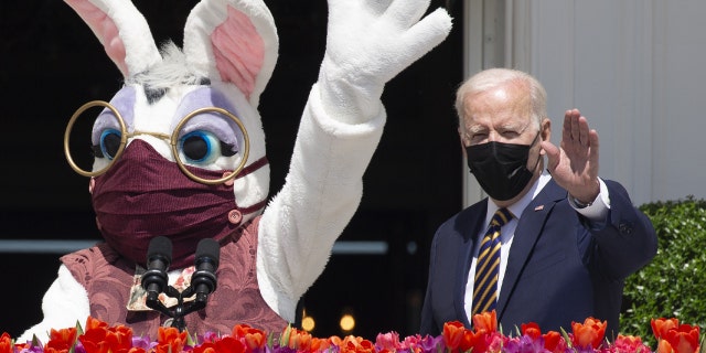 President Biden, right, beside a costumed Easter bunny from the Truman Balcony of the White House in Washington, D.C., on Monday, April 5, 2021. Biden and the bunny, both outdoors, are wearing masks. (Michael Reynolds/EPA/Bloomberg via Getty Images)