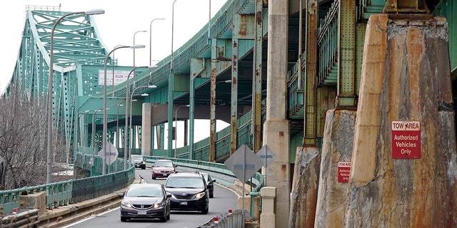 Drivers take an exit ramp off the Tobin Memorial Bridge, Wednesday, March 31, 2021, in Chelsea, Mass. (AP Photo/Steven Senne)