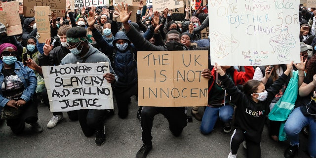 FILE - In this file photo dated Saturday, June 6, 2020, demonstrators gather outside Downing Street during a Black Lives Matter march in London. (AP Photo/Frank Augstein, FILE)