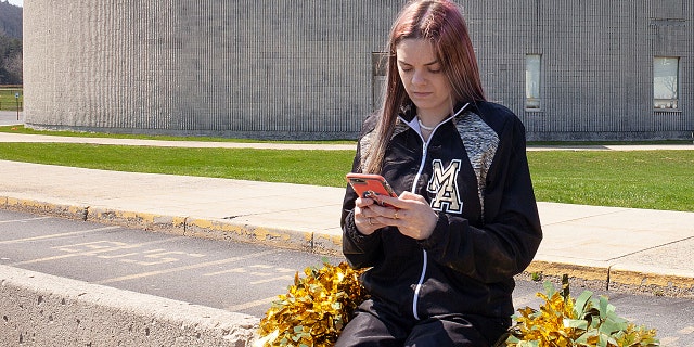Brandi Levy, a former cheerleader at Mahanoy Area High School in Mahanoy City, Pennsylvania and a key figure in a major U.S. case about free speech, uses her phone in an undated photograph provided by the American Civil Liberties Union.
