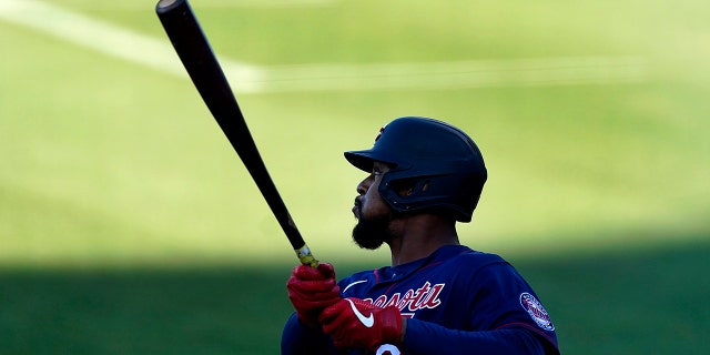 Minnesota Twins' Byron Buxton follows through on a three-run double during the first inning of the team's spring training baseball game against the Boston Red Sox on Thursday, March 25, 2021, in Fort Myers, Fla. (AP Photo/John Bazemore)
