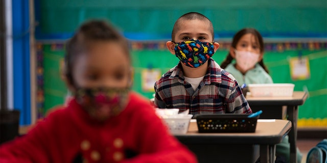 Kindergarten students sit in their classroom on the first day of in-person learning at Maurice Sendak Elementary School in Los Angeles, Tuesday, April 13, 2021. More than a year after the pandemic forced all of California's schools to close classroom doors, some of the state's largest school districts are slowly beginning to reopen this week for in-person instruction. 