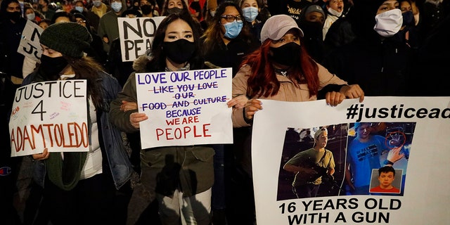 Protesters protest the fatal March shooting by police of 13-year-old Adam Toledo on Friday, April 16, 2021, in the Logan Square area of ​​Chicago.  (Associated Press)