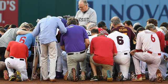 Democrats and Republicans gather at second base for a prayer prior to the start of the Congressional baseball game with the house chaplain leading the way on June 15, 2017 in Washington, DC. 