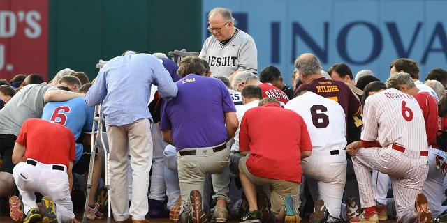 Democrats and Republicans gather at second base for a prayer prior to the start of the Congressional baseball game with the house chaplain leading the way on June 15, 2017 in Washington, DC.