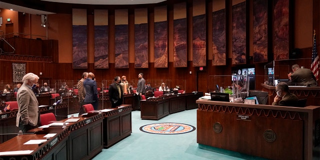 FILE - In this Feb. 18, 2021 file photo State representatives gather at the Capitol, in Phoenix.  (AP Photo/Matt York,File)