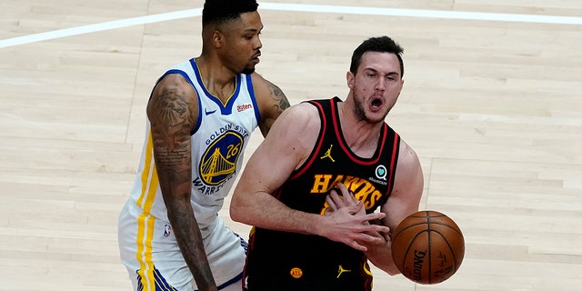 Atlanta Hawks forward Danilo Gallinari (8) is fouled by Golden State Warriors forward Kent Bazemore (26) in the second half of a game April 4, 2021, in Atlanta.