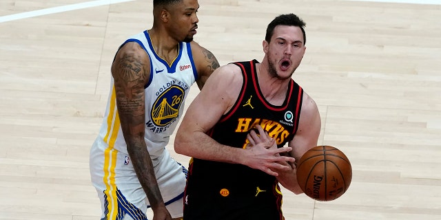 Atlanta Hawks forward Danilo Gallinari (8) is fouled by Golden State Warriors forward Kent Bazemore (26) in the second half of a game April 4, 2021, in Atlanta.