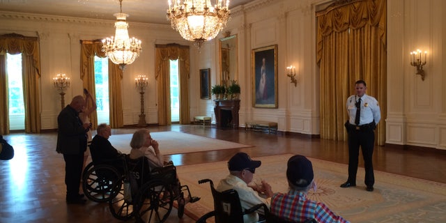 Sgt. Jonathan Stockeland showing World War II veterans around the White House. The 2017 tour included survivors of the USS Arizona. 