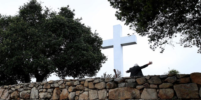 On April 12, 2020, a pastor gives a sermon during a sunrise Easter service outdoors, at Mt. Helix Park in San Diego, California.