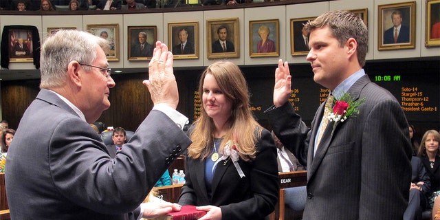 FILE - In this Nov. 20, 2012, file photo State Sen. Don Gaetz, R-Niceville, left, is sworn in as Senate president by his son, state Rep. Matt Gaetz, R-Fort Walton Beach, as his daughter, Erin, holds the family bible on Tuesday, Nov. 20, in Tallahassee, Fla. (AP Photo/Bill Cotterell, File)