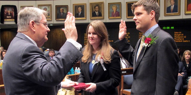 FILE - In this Nov. 20, 2012, file photo State Sen. Don Gaetz, R-Niceville, left, is sworn in as Senate president by his son, state Rep. Matt Gaetz, R-Fort Walton Beach, as his daughter, Erin, holds the family bible on Tuesday, Nov. 20, in Tallahassee, Fla. (AP Photo/Bill Cotterell, File)