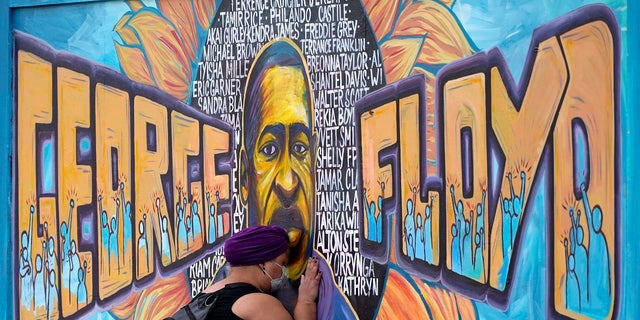 A mural by George Floyd in Minneapolis, Minn.  The Texas Board of Pardons and Lyrics recommends that Floyd be pardoned for a 2004 drug arrest in Houston. 
