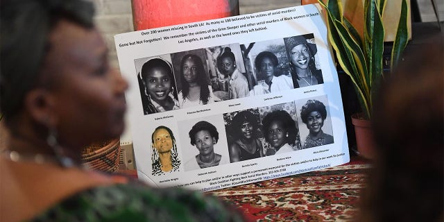 People look at photos of known victims of Lonnie Franklin, Samuel Little and other Los Angeles-based serial killers at a memorial service in Los Angeles, California on December 8, 2018. According to the Black Coalition Fighting Back Against Serial Murders, at least 200 African American women have disappeared in mysterious circumstances in the past few years.