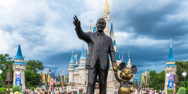 Disney World guests gather near the Walt Disney and Mickey Mouse statue inside of the Magic Kingdom theme park in this July 2019 photo. (Roberto Machado Noa/LightRocket via Getty Images)