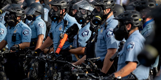 Minneapolis Police officers lined up as demonstrators protested the killing of George Floyd outside the Minneapolis Police Department's Third Precinct office in south Minneapolis. 