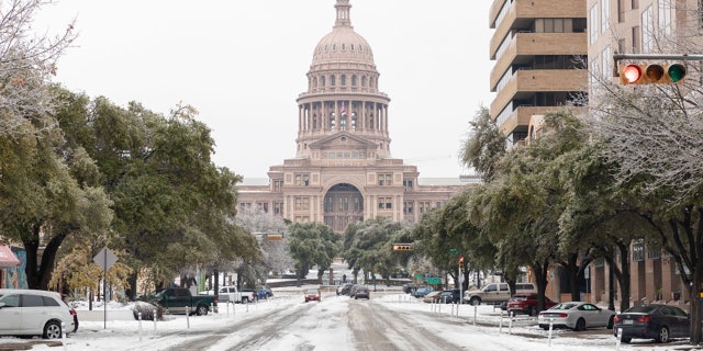 A snow-covered road near the Texas State Capitol Building in Austin, Texas, U.S., on Wednesday, Feb. 17, 2021. Photographer: Thomas Ryan Allison/Bloomberg via Getty Images