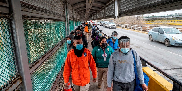 Migrants approach the U.S. border on Gateway International Bridge in Brownsville, Texas on March 2, 2021. (Getty Images)