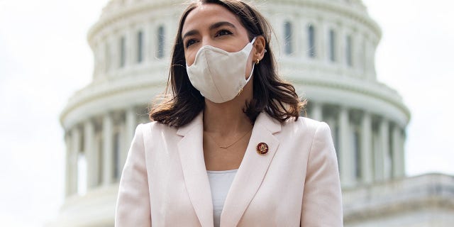 US Representative Alexandria Ocasio-Cortez, Democrat of New York, attends a press conference about a postal banking pilot program outside the US Capitol in Washington, DC, April 15, 2021. The clashes between Ocasio-Cortez and House Speaker Nancy Pelosi, D-Calif., are detailed in a new biography of Pelosi by USA Today's Susan Page. (Photo by SAUL LOEB / AFP)