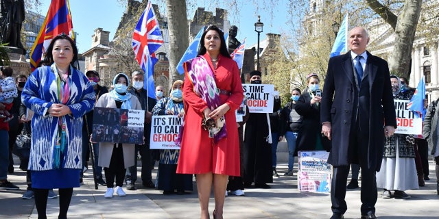 British Conservative Party MPs Nusrat Ghani (C) and Iain Duncan Smith (R) join members of the Uyghur community as they demonstrate to call on the British parliament to vote to recognize alleged persecution of China's Muslim minority Uyghur people as genocide and crimes against humanity in London on April 22, 2021. (Photo by JUSTIN TALLIS / AFP) (Photo by JUSTIN TALLIS/AFP via Getty Images)