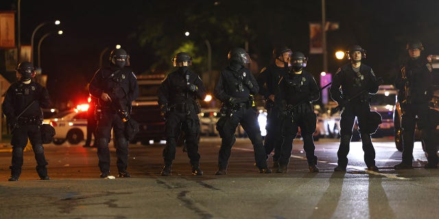 Police officers stand in formation during a standoff with demonstrators in front of the Public Safety Building Sept. 7, 2020, in Rochester, N.Y.