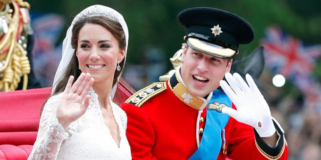 Catherine, Duchess of Cambridge and Prince William, Duke of Cambridge (wearing his red tunic uniform of the Irish Guards, of which he is Colonel) travel down The Mall, on route to Buckingham Palace, in the 1902 State Landau horse-drawn carriage following their wedding ceremony at Westminster Abbey on April 29, 2011, in London, England. The marriage of Prince William, the second in line to the British throne to Catherine Middleton was led by the Archbishop of Canterbury and was attended by 1900 guests, including foreign Royal family members and heads of state. Thousands of well-wishers from around the world have also flocked to London to witness the spectacle and pageantry of the royal wedding. 