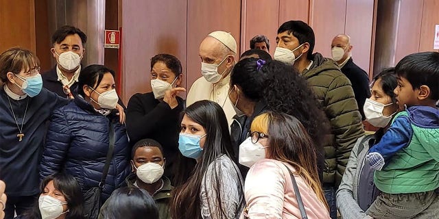 Pope Francis poses with the vaccinated at the Paul VI Hall Vatican Vaccination Centre on April 02, 2021, in Vatican City, Vatican. On Good Friday, before the celebration of the Way of the Cross, Pope Francis visited with the homeless and those needing special assistance while they received Covid vaccinations provided by the Vatican. He greeted the volunteers, doctors and nurses assisting them.