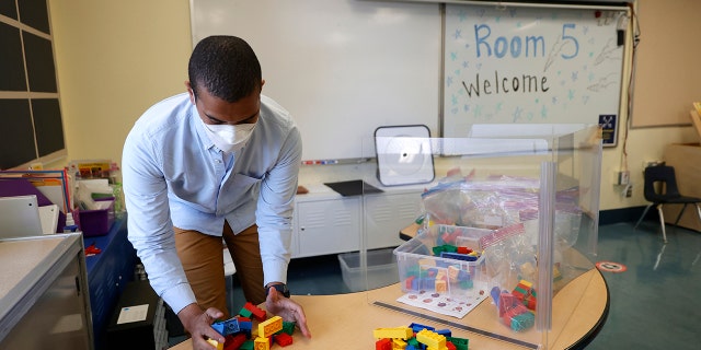 Bryant Elementary School kindergarten teacher Chris Johnson sets up his classroom on April 09, 2021, in San Francisco, California.