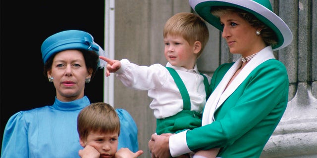 Diana, Princess Of Wales, holding Prince Harry as she watched Trooping the Colour with Prince William and Princess Margaret from the balcony of Buckingham Palace.