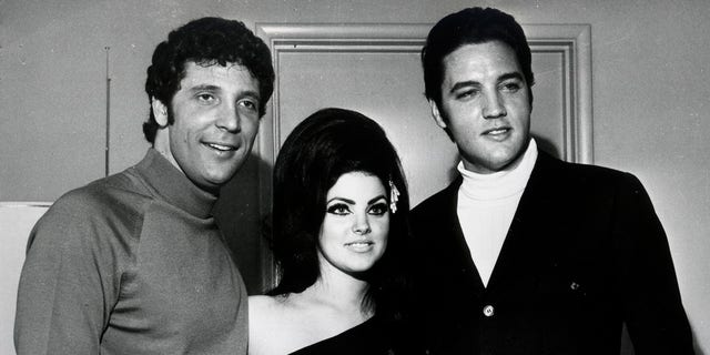  Elvis Presley (R) and Tom Jones pose for a portrait with Elvis' wife Priscilla Beaulieu Presley on April 7, 1968, in Las Vegas, Nevada. 