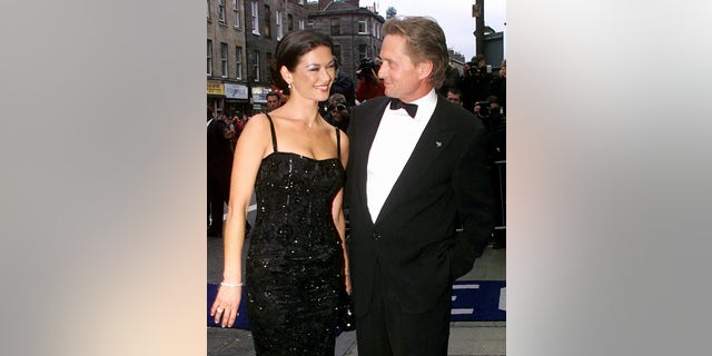 Catherine Zeta-Jones and Michael Douglas arrive at Edinburgh's Odeon cinema for the UK premiere of the film ‘Entrapment,’ circa 1999.