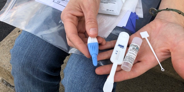 March 9, 2021: In this file photo, Solutions Oriented Addiction Response organizer Brooke Parker displays an HIV testing kit in Charleston, W.Va.