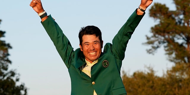 Hideki Matsuyama, of Japan, celebrates after putting on the champion's green jacket after winning the Masters golf tournament on Sunday, April 11, 2021, in Augusta, Ga.