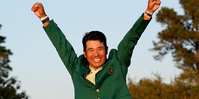 Hideki Matsuyama, of Japan, celebrates after putting on the champion's green jacket after winning the Masters golf tournament on Sunday, April 11, 2021, in Augusta, Ga.