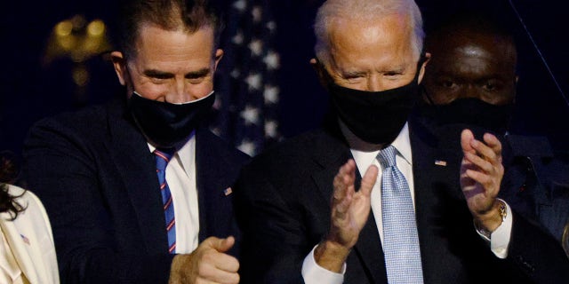 Democratic 2020 U.S. presidential nominee Joe Biden, right, and his son Hunter celebrate onstage at his election rally in Wilmington, Delaware, after the news media announced that Biden won the election on Nov. 7, 2020.