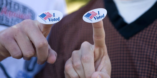 Young voters show the "I Voted" stickers after voting at a polling station in Plano, Texas, the United States, Nov. 3, 2020. (Photo by Dan Tian/Xinhua via Getty) (Xinhua/Dan Tian via Getty Images)