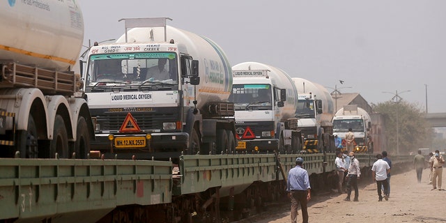 April 19, 2021: Empty tankers are loaded on a train wagon at the Kalamboli goods yard in Navi Mumbai, Maharashtra state, India, before they are transported to collect liquid medical oxygen from other states. 
