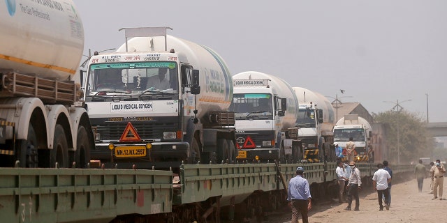 April 19, 2021: Empty tankers are loaded on a train wagon at the Kalamboli goods yard in Navi Mumbai, Maharashtra state, India, before they are transported to collect liquid medical oxygen from other states.