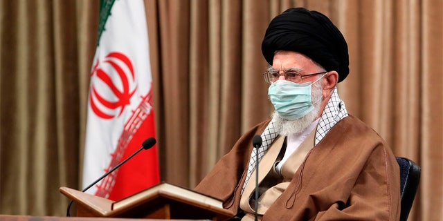 In this picture released by an official website of the office of the Iranian supreme leader, Supreme Leader Ayatollah Ali Khamenei wearing a protective face mask, attends a meeting in Tehran, Iran, Wednesday, April 14, 2021.  (Office of the Iranian Supreme Leader via AP)