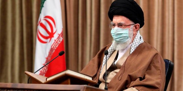 In this picture released by an official website of the office of the Iranian supreme leader, Supreme Leader Ayatollah Ali Khamenei wearing a protective face mask, attends a meeting in Tehran, Iran, Wednesday, April 14, 2021.  (Office of the Iranian Supreme Leader via AP)