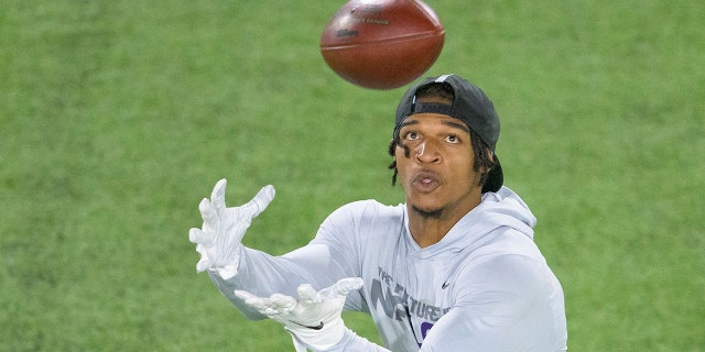 File-This March 31, 2021, file photo shows LSU wide receiver Ja'Marr Chase catching during a drill at an NFL Pro Day at LSU in Baton Rouge, La. (AP Photo/Matthew Hinton, File)
